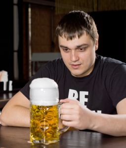 Man staring at a beer
